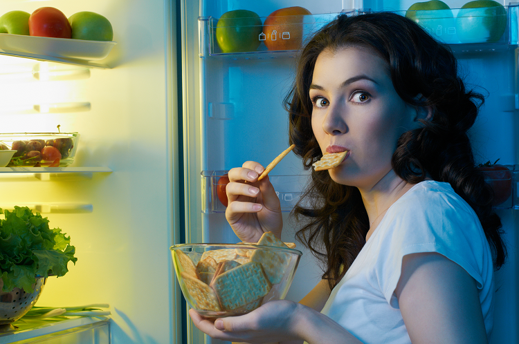 夜になるとついついたくさん食べてしまう原因は？（写真：Shutterstock.com）